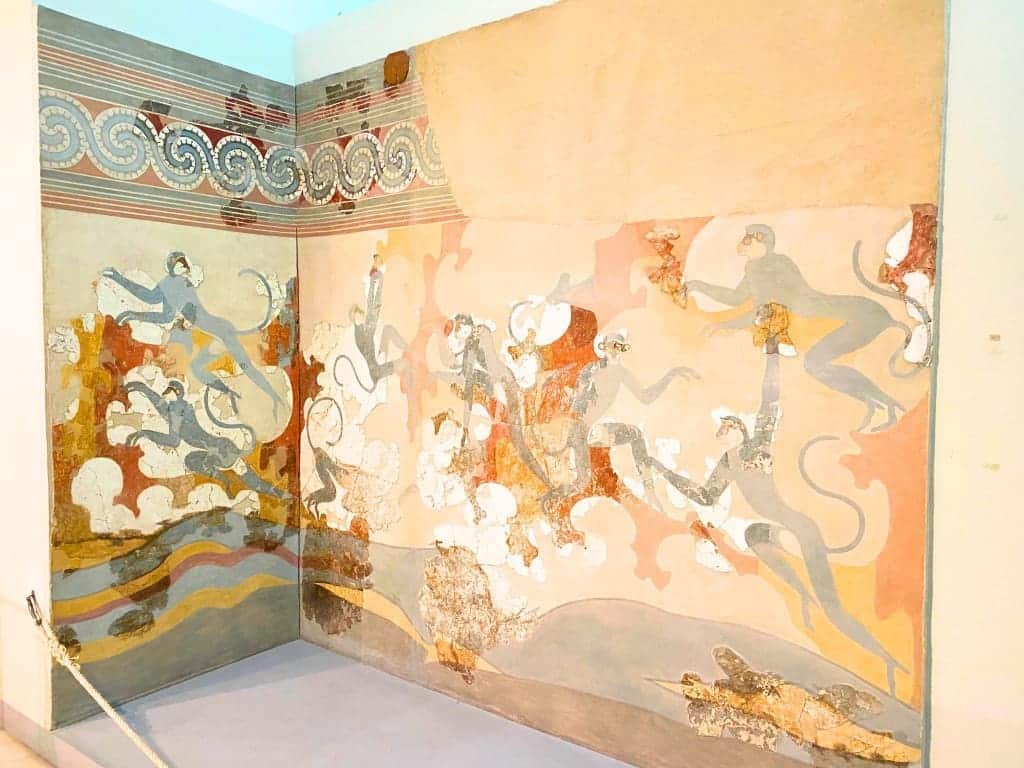 Santorini, Greece Travel Guide: Essential Tips for First-Time Visitors 15 The “Blue Monkeys Fresco” from Akrotiri, displayed at the Museum of Prehistoric Thera in Santorini, Greece, depicting vividly painted blue monkeys climbing rocks and interacting playfully in a stylized natural landscape.
