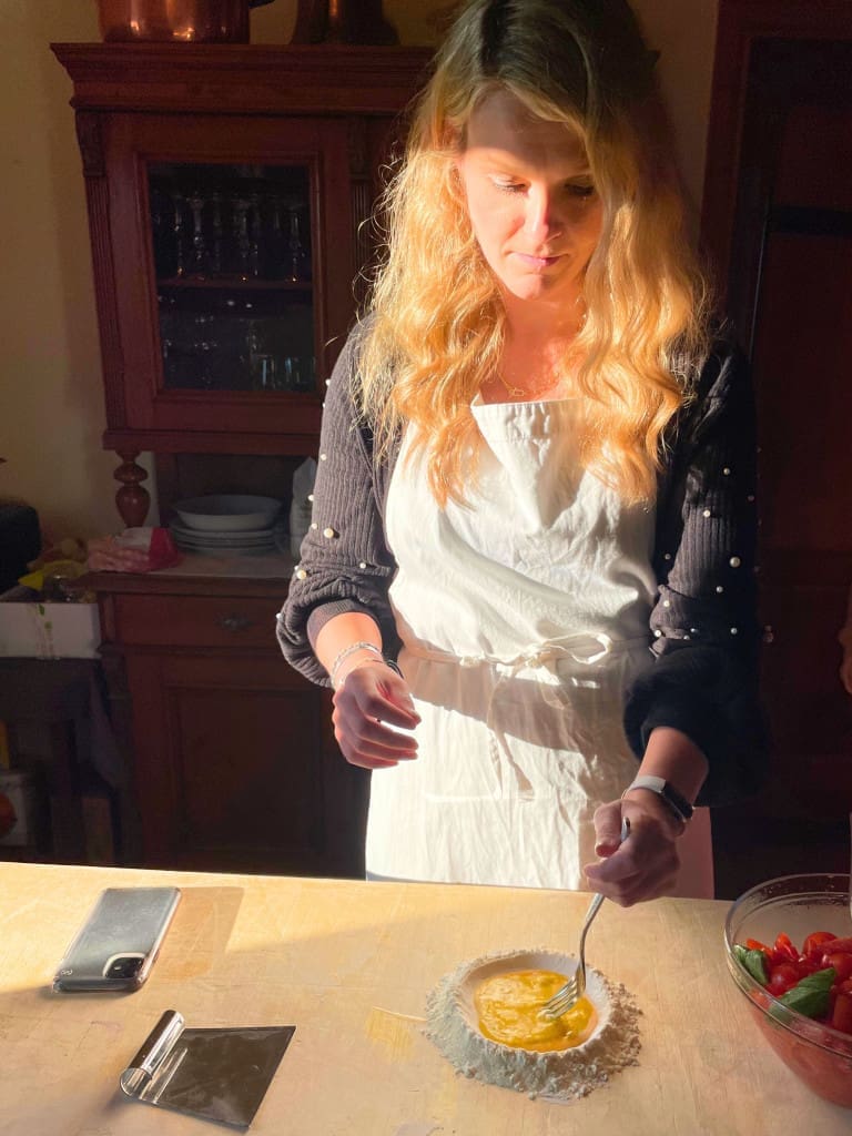 Bumble BFF Review: How I Easily Met My Travel Buddy on This App 6 Woman mixing ingredients at an Italian cooking class
