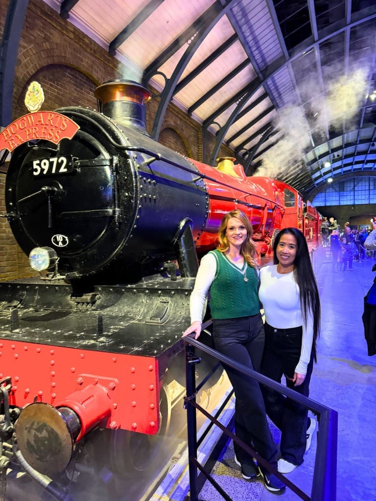 Bumble BFF Review: How I Easily Met My Travel Buddy on This App 11 Two women standing next to the Hogwarts Express in London