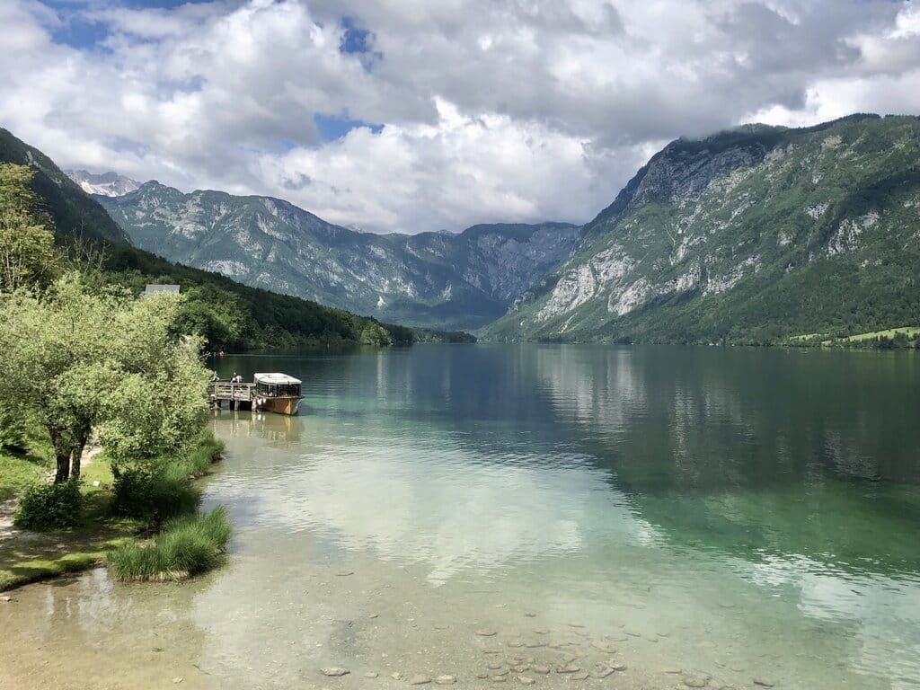 18 of the Best Things to Do in Slovenia: Your Ultimate Travel Guide 27 boat docked lake bohinj slovenia