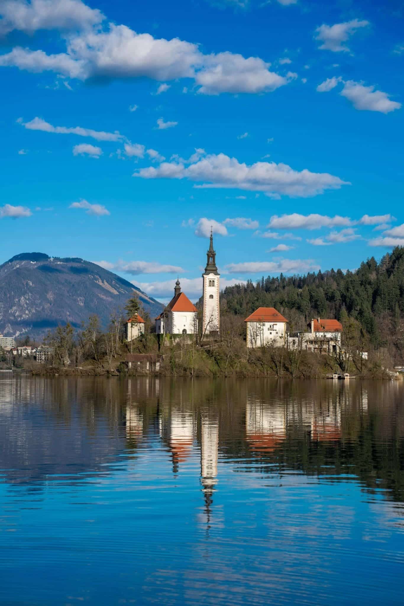 18 of the Best Things to Do in Slovenia: Your Ultimate Travel Guide 2 lake bled island julian alps reflection slovenia