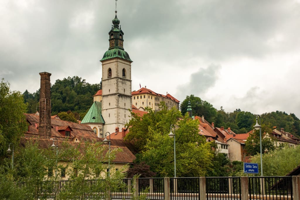 18 of the Best Things to Do in Slovenia: Your Ultimate Travel Guide 15 st jacob church castle skofja loka slovenia