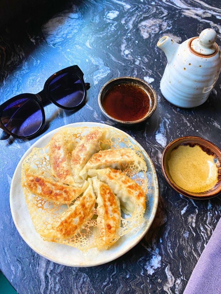 How to Spend 3 Days in Barcelona: A First-Timer's Travel Itinerary 75 dumplings plate sunglasses robata restaurant barcelona
