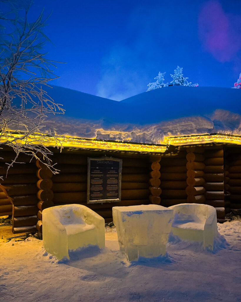 Rovaniemi in Winter: How to Build a First-Timer's Itinerary for Finnish Lapland 17 nighttime ice sculpture chairs at santas village rovaniemi