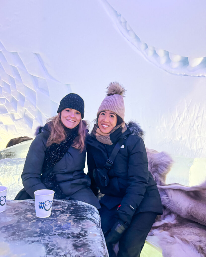 Rovaniemi in Winter: How to Build a First-Timer's Itinerary for Finnish Lapland 108 two women enjoying ice bar in snowman world rovaniemi