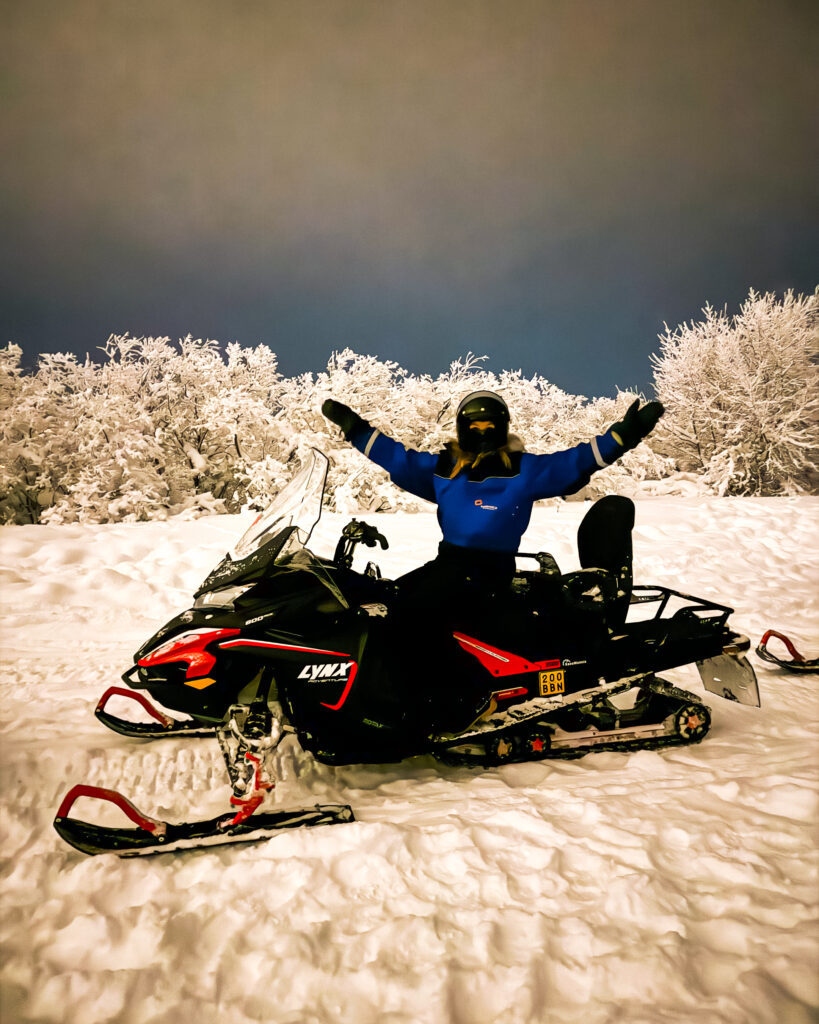 Rovaniemi in Winter: How to Build a First-Timer's Itinerary for Finnish Lapland 51 winter adventure woman snowmobiling in rovaniemi