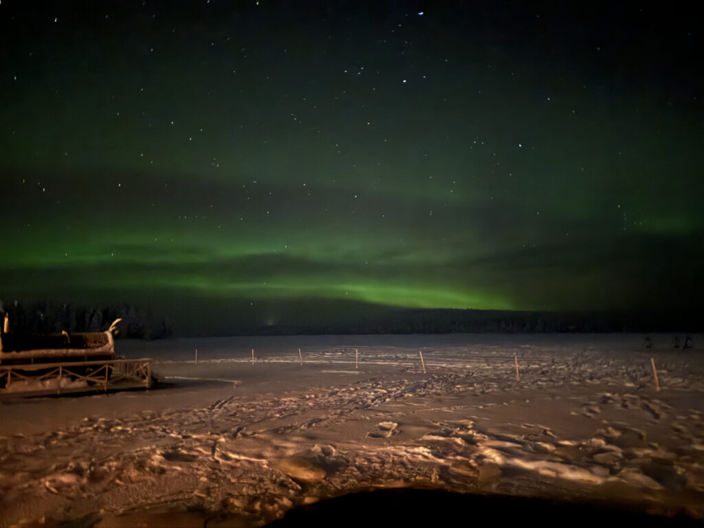 Guide to Spotting the Aurora Borealis in Rovaniemi, Finland 2 night sky aurora snow landscape wooden structure