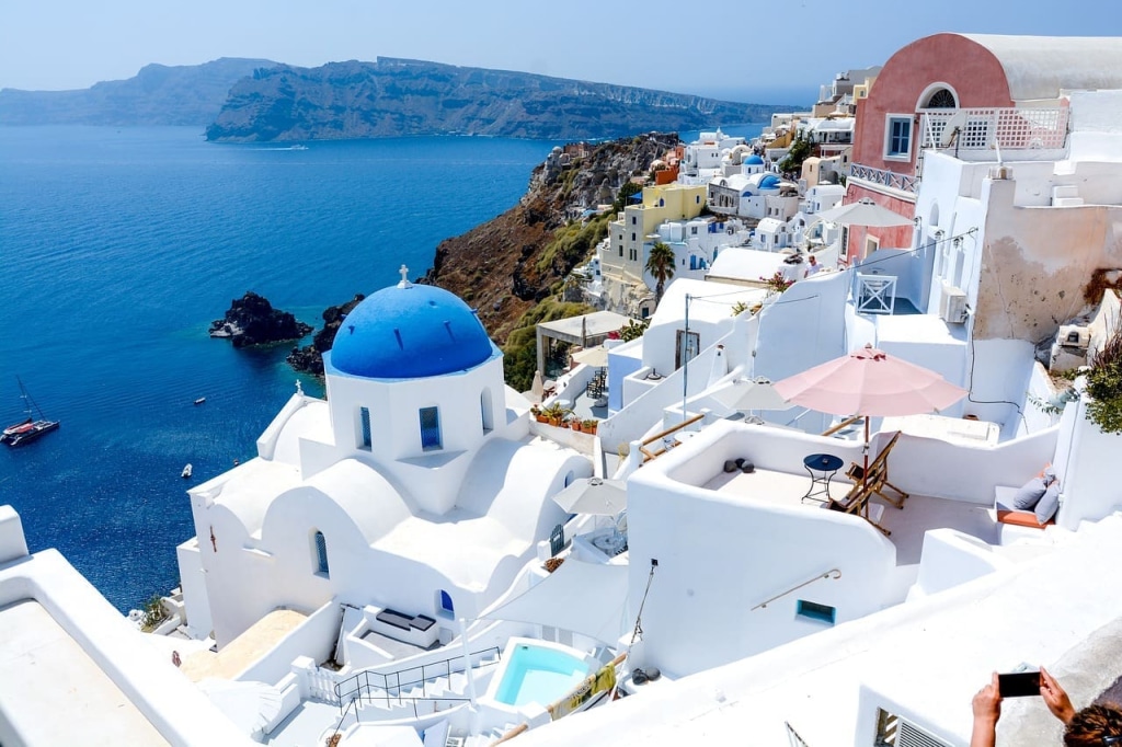 Santorini, Greece Travel Guide: Essential Tips for First-Time Visitors 2 whitewashed buildings blue domes aegean sea santorini